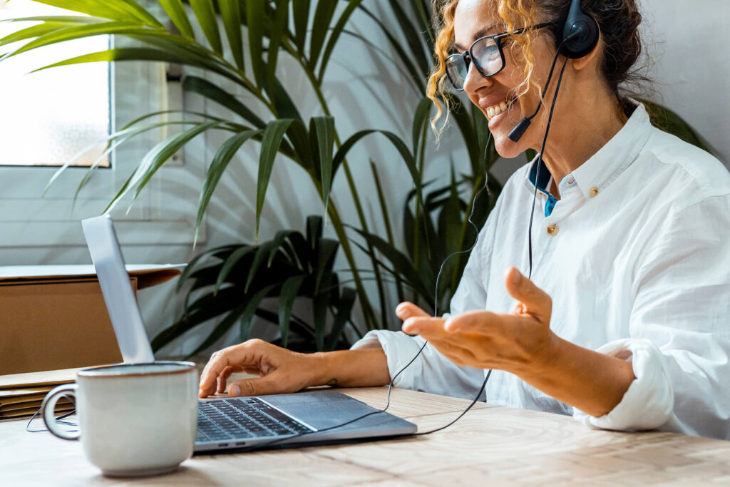 Professional conducting Spotfire training and data visualization training remotely, wearing a headset and demonstrating interactive dashboard techniques on a laptop as part of a hands-on Spotfire course and Spotfire bootcamp.